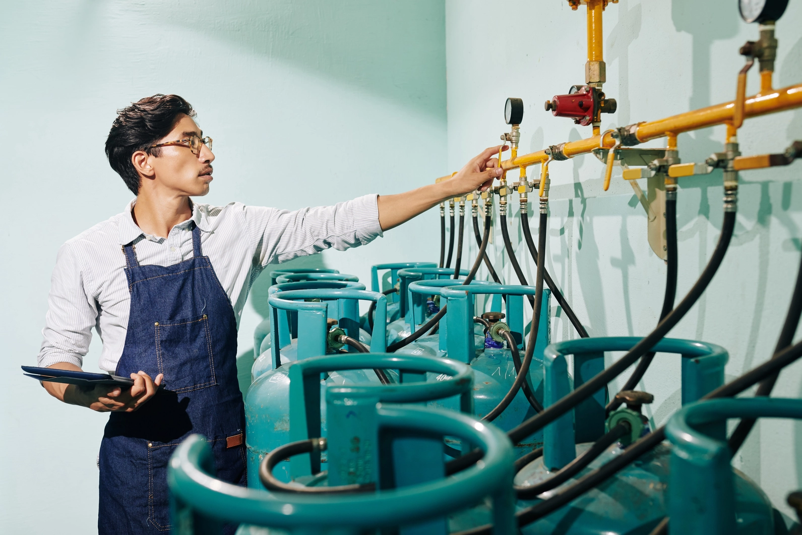 roastery worker checking pressure