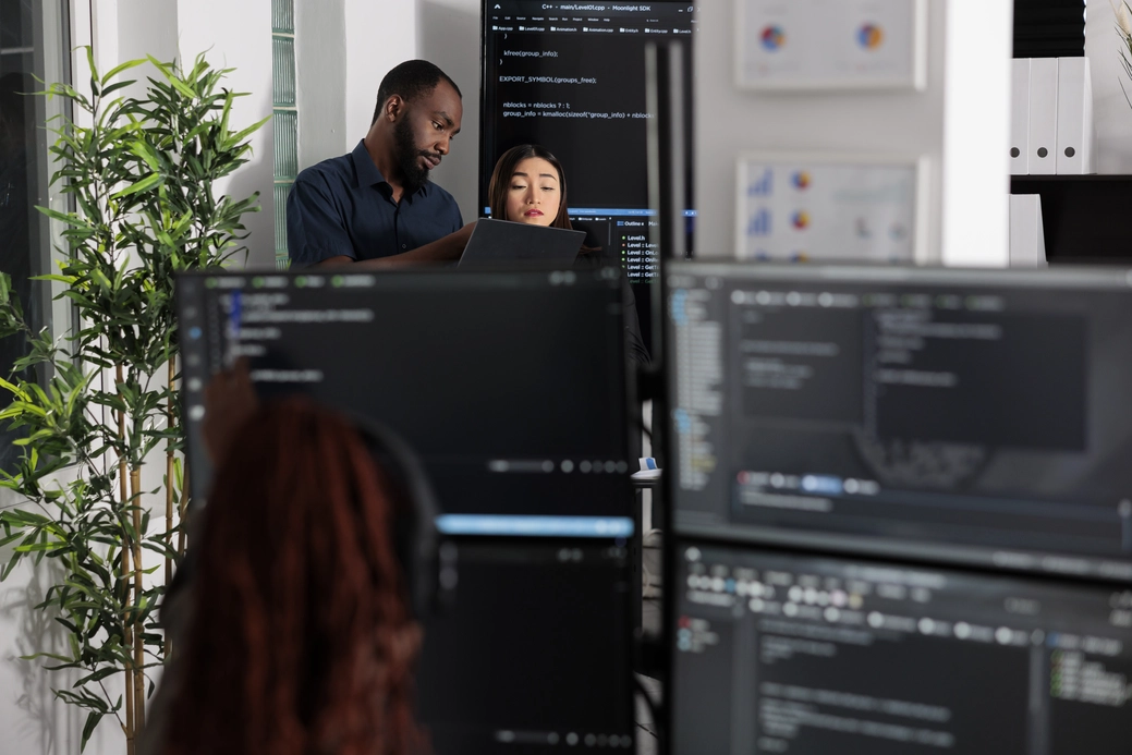 team of app developers looking at coding algorithm